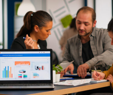 Business woman talking about financial project using laptop