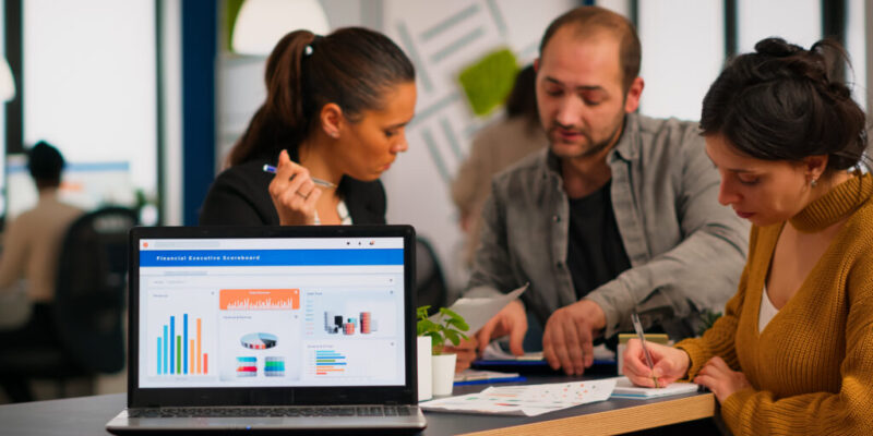 Business woman talking about financial project using laptop