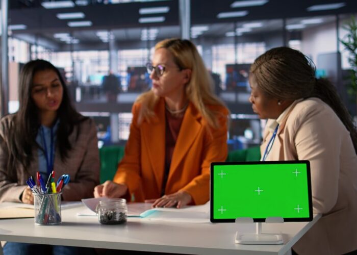 Group of businesswomen sharing insight on a new project next to copy space