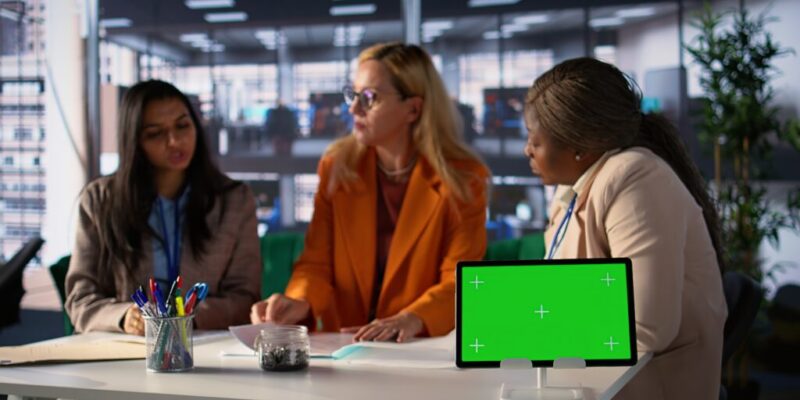 Group of businesswomen sharing insight on a new project next to copy space